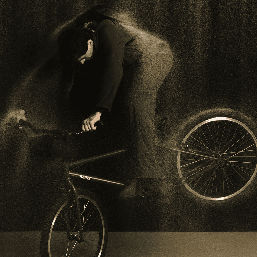 Bicycle rider performing stunt indoors for lifestyle and fitness photography.