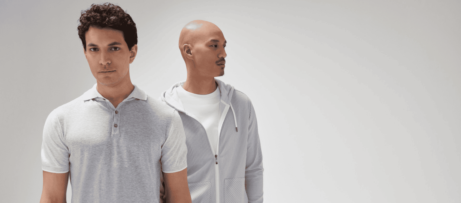 Men wearing casual minimalistic loungewear in a neutral setting.