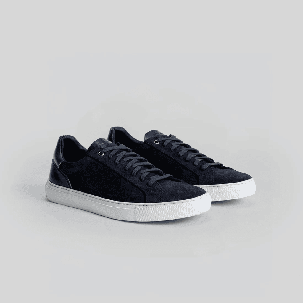 Stylish black and white sneakers with a sleek design, perfect for casual and streetwear fashion.