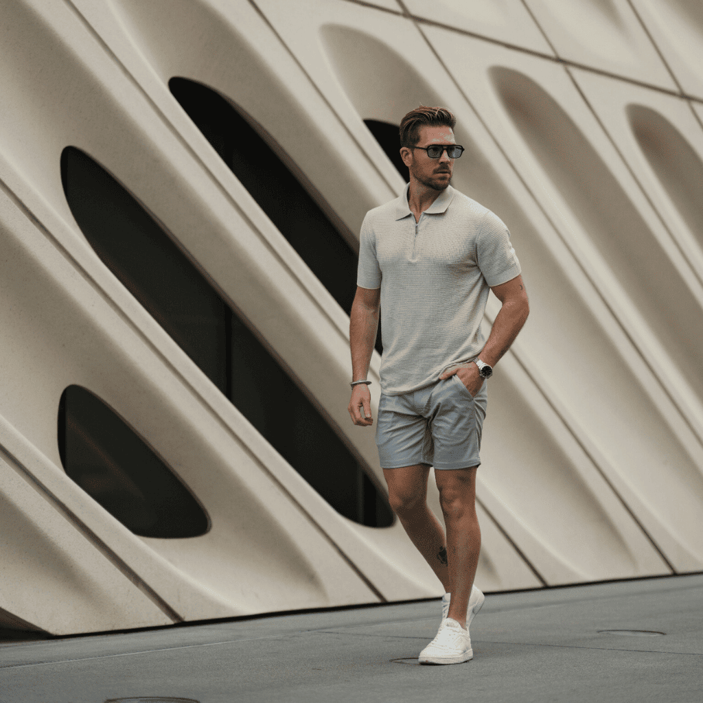 Luxury men's summer casual fashion, modern polo shirt, shorts, sneakers, sunglasses, urban street style.