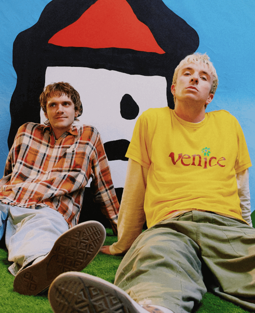 Plaid shirt casual fashion scene with graffiti art background, young men sitting on grass.