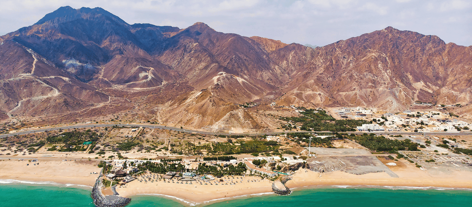Luxurious beach resort with scenic mountain views and oceanfront amenities.