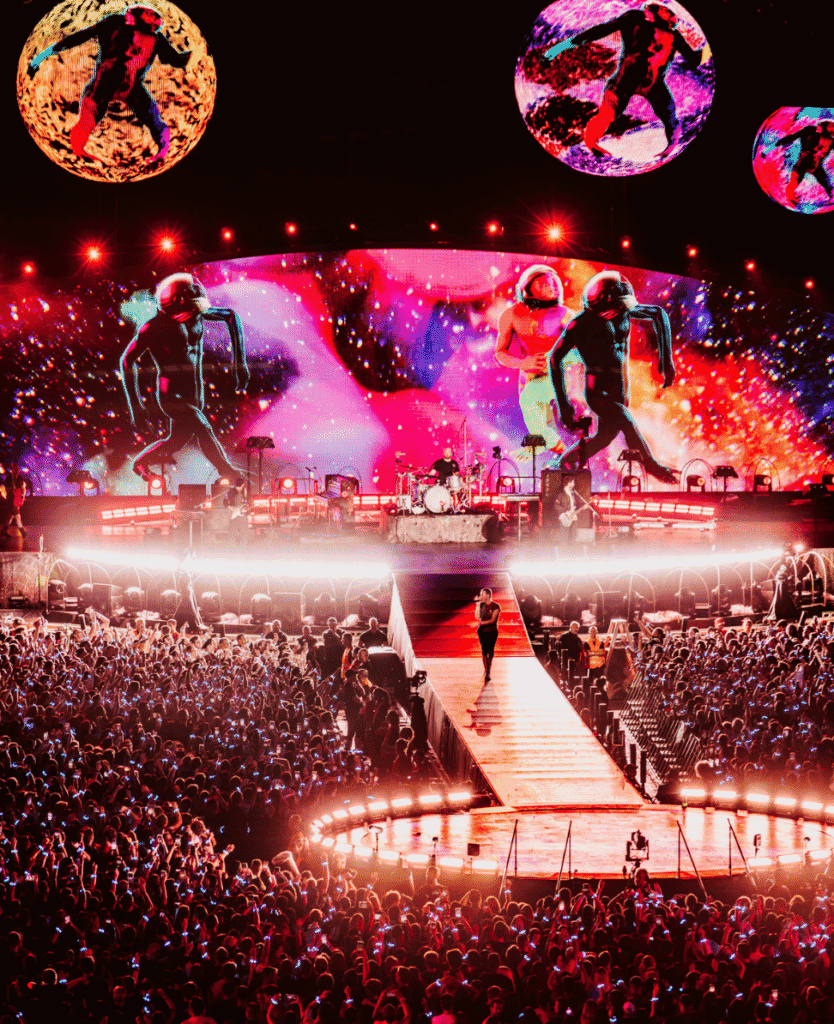 ULUS-1981-live concert stage with vibrant LED visuals and energetic crowd at night.