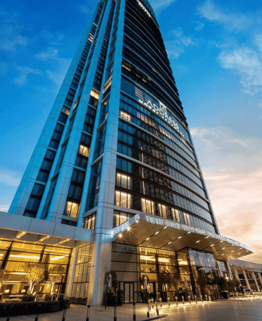 Skyline view of modern high-rise office building during evening, illuminated from within.