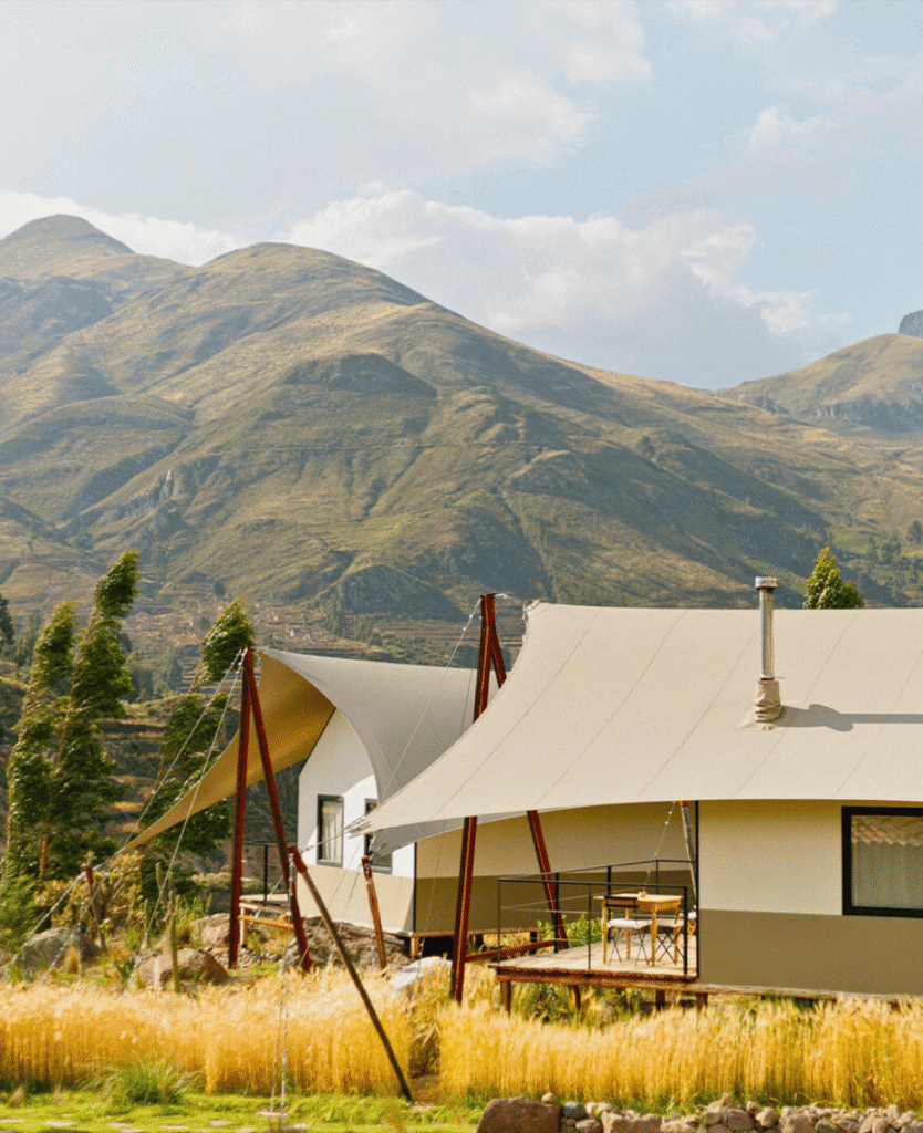Modern house with unique architectural design and mountain backdrop.
