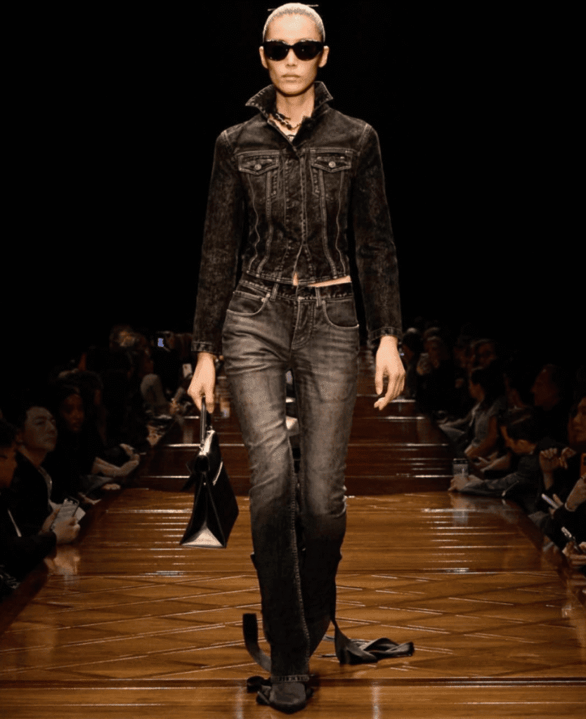 Black denim jacket and jeans fashion model walking on runway for Lush Collective.