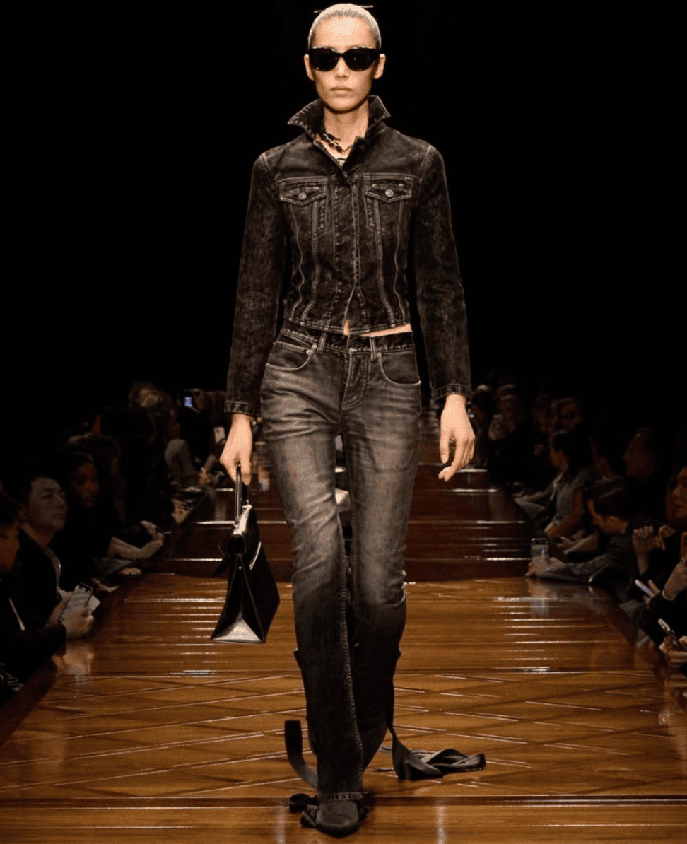 Black denim jacket and jeans fashion model walking on runway for Lush Collective.