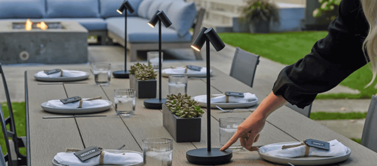Elegant outdoor dining table setup for stylish garden gatherings with modern lighting and decor.