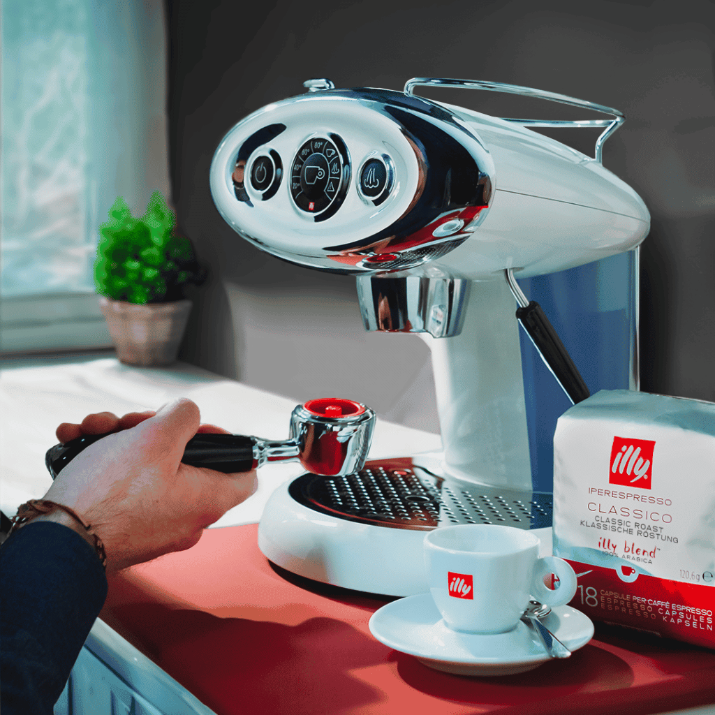 Shiny espresso machine brewing coffee at home, coffee beans and cups on countertop, cozy kitchen setting.