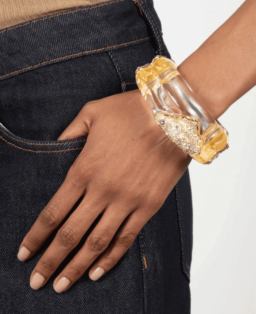 Gold and clear acrylic statement bracelet with rhinestone embellishments, fashionable jewelry accessory.