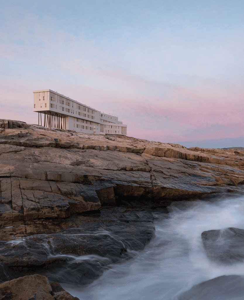 Lush Collective architecture by the coast at sunset, modern design and ocean views.