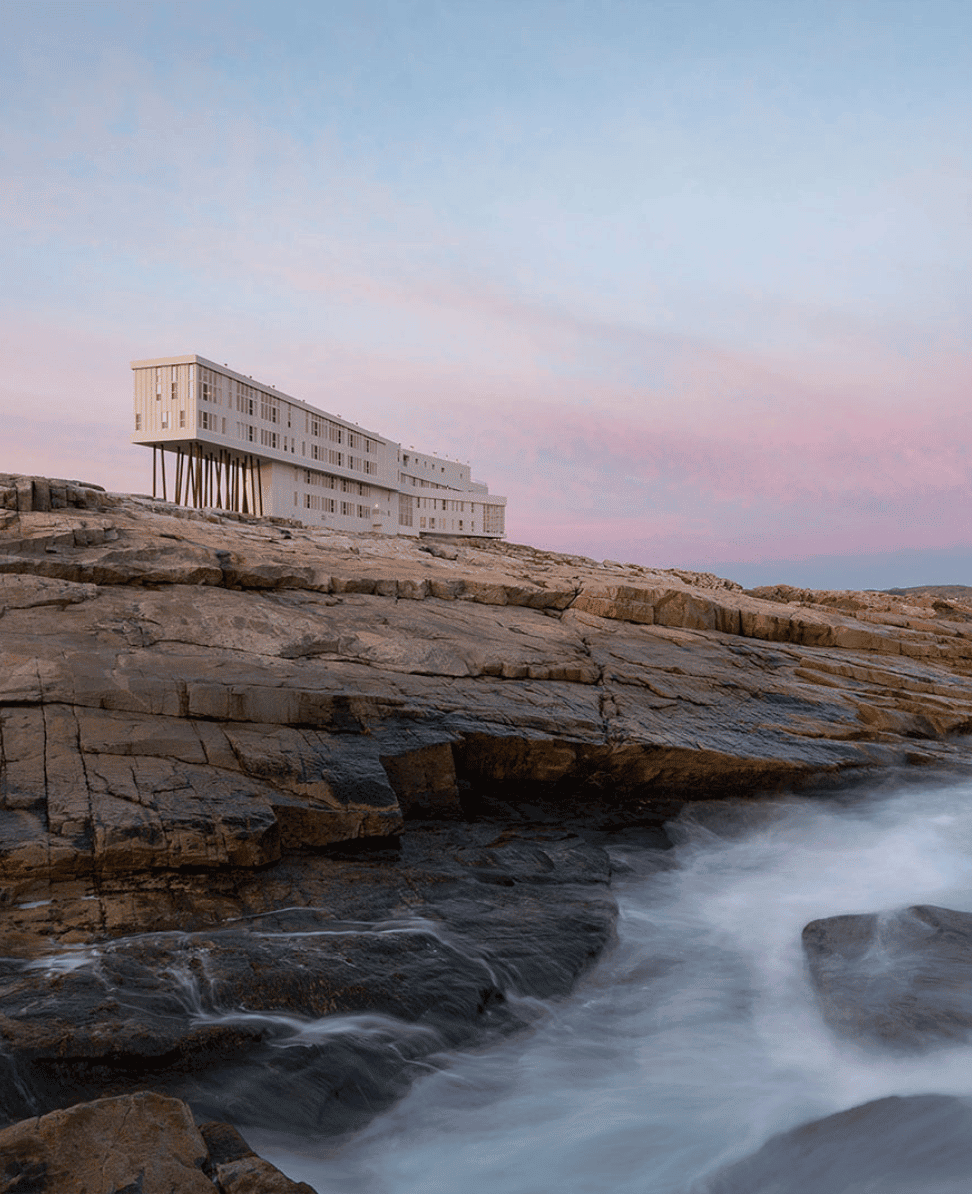Lush Collective architecture by the coast at sunset, modern design and ocean views.