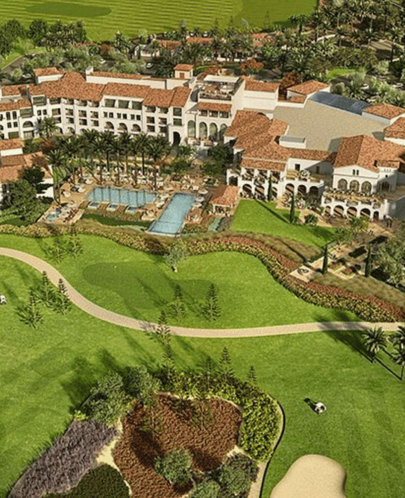 Luxury resort with swimming pools, lush landscaping, and Mediterranean architecture in a scenic setting.