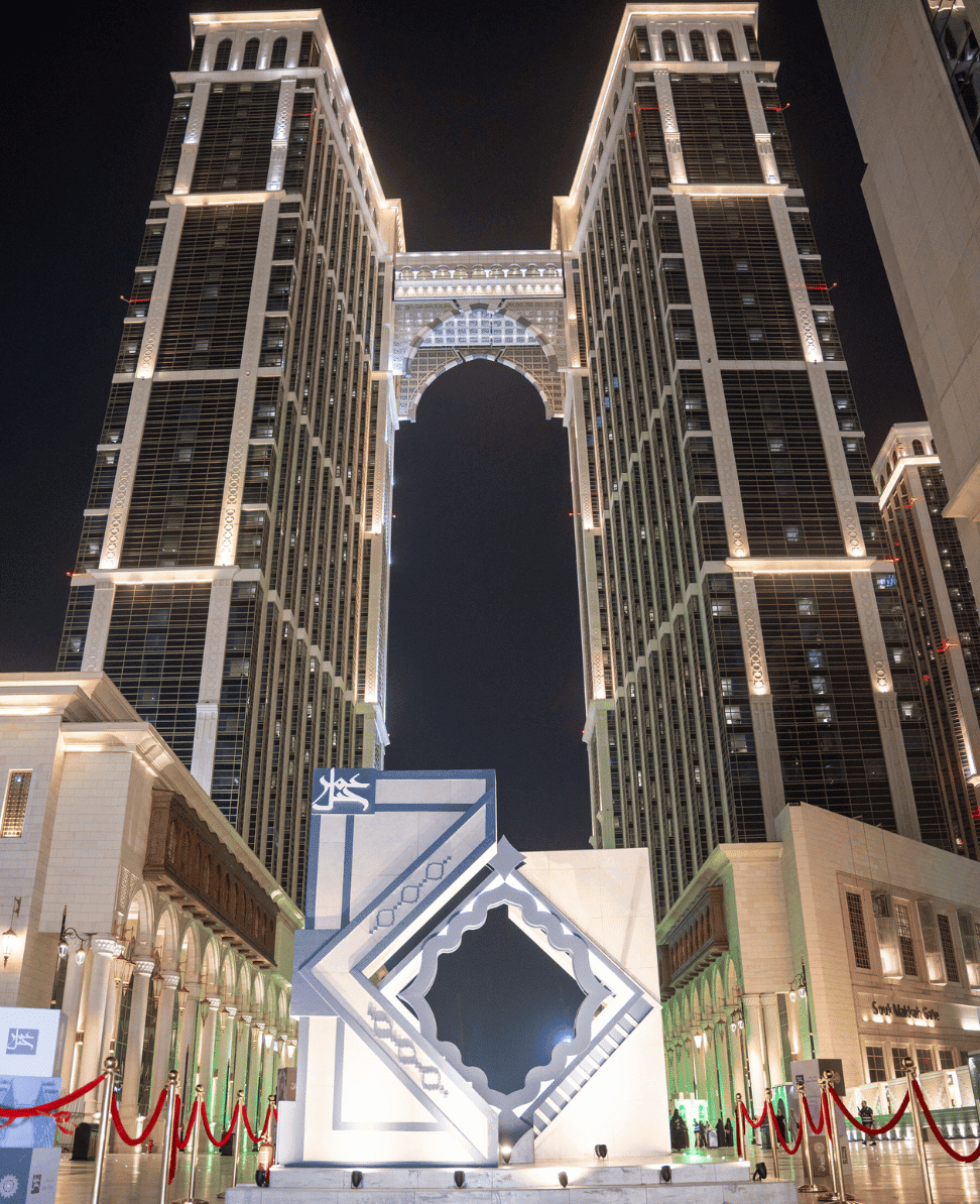 Luxury high-rise buildings illuminated at night Dubai architectural landmark.