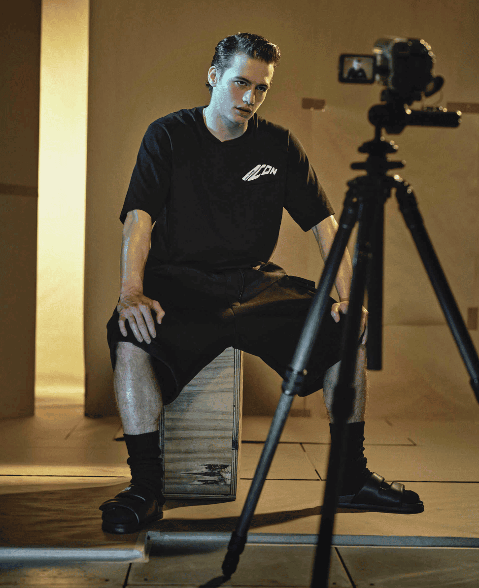 Clothing for photoshoot, model in black athletic wear, studio setting, professional photography session.