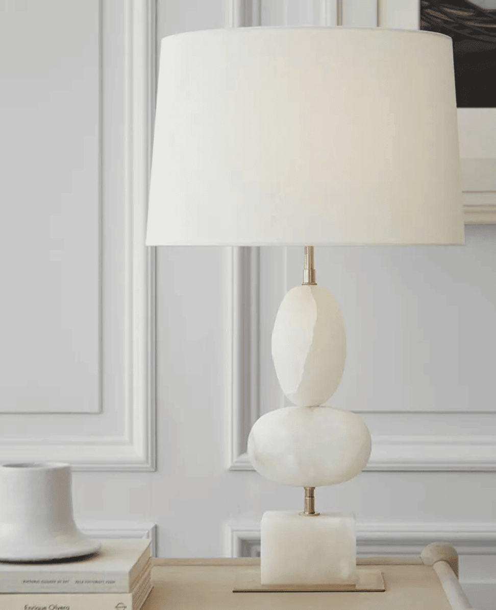 Modern minimalist table lamp with stone base and neutral shade for elegant home decor.
