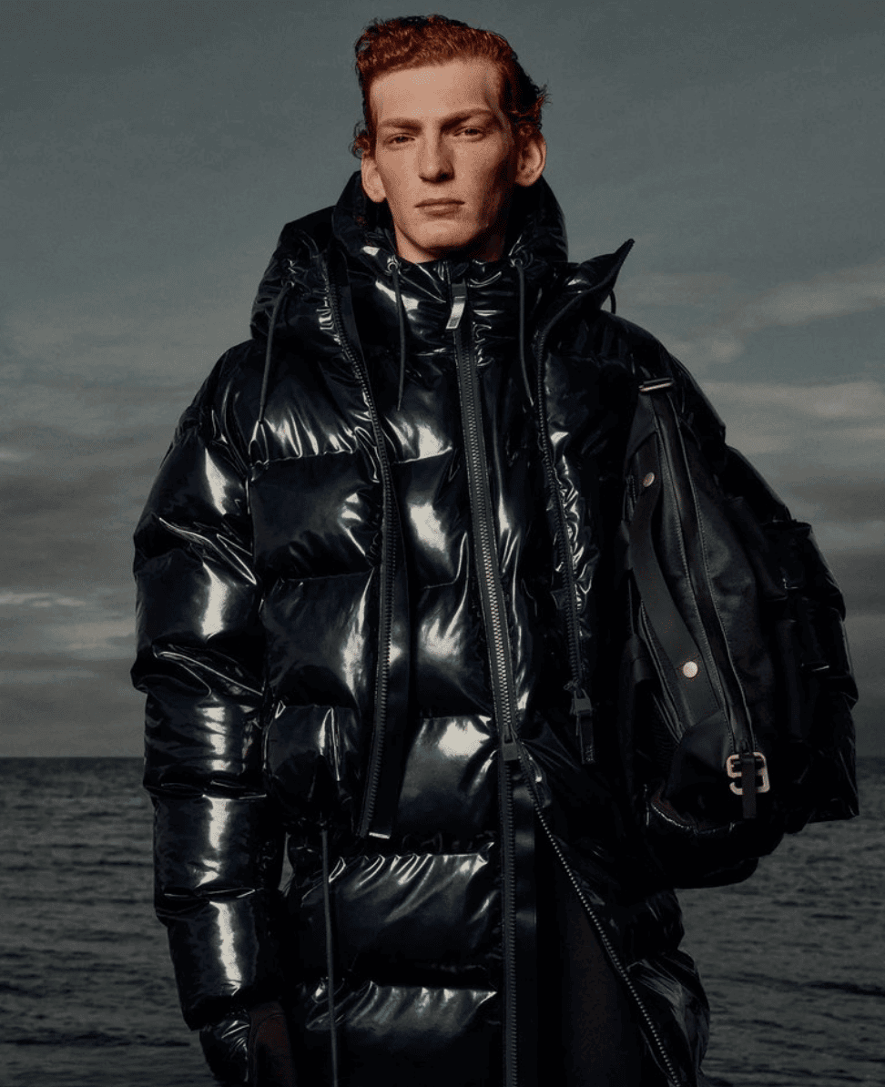 Black shiny puffer jacket, urban streetwear style, edgy winter fashion, outdoor winter apparel.